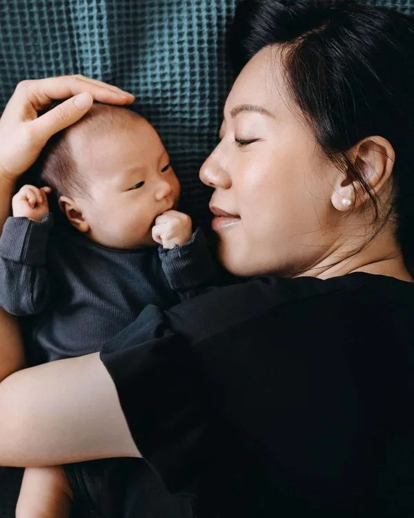 A mother resting with her baby